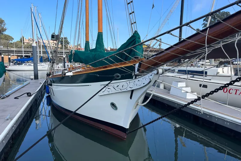Slide: The Image of Vintage 1947 Murray Peterson Schooner docked at marina, showcasing elegant design and craftsmanship. - 6