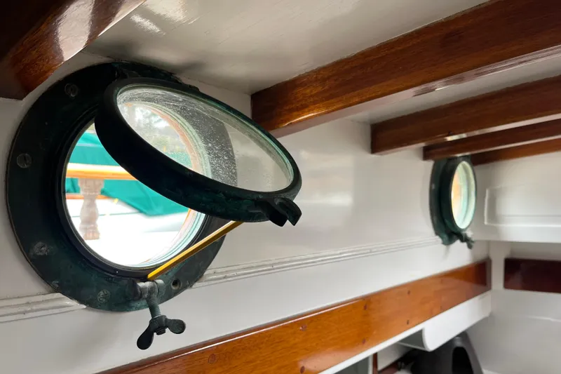 Slide: The Image of Interior view of 1947 Murray Peterson Schooner with open portholes and wooden beams. - 64