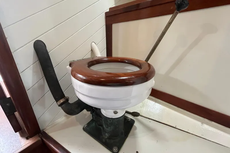 Slide: The Image of Vintage marine toilet on 1947 Murray Peterson Schooner with wooden seat and manual pump. - 69