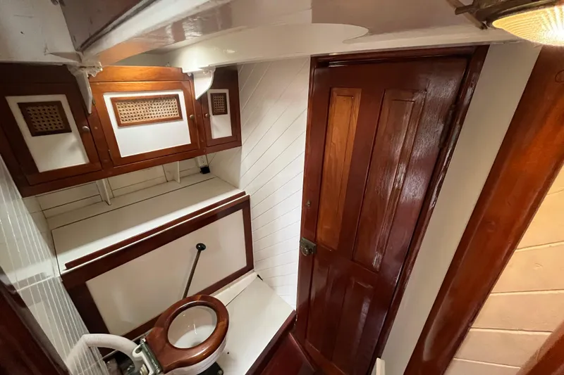 Slide: The Image of Vintage 1947 Murray Peterson Schooner bathroom with wooden cabinetry and nautical design. - 70