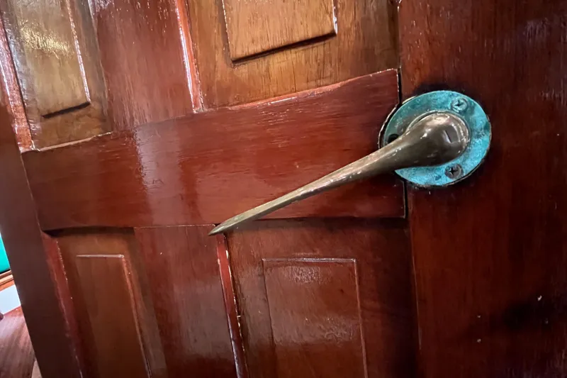 Slide: The Image of Wooden door with vintage brass handle on 1947 Murray Peterson Schooner. - 71