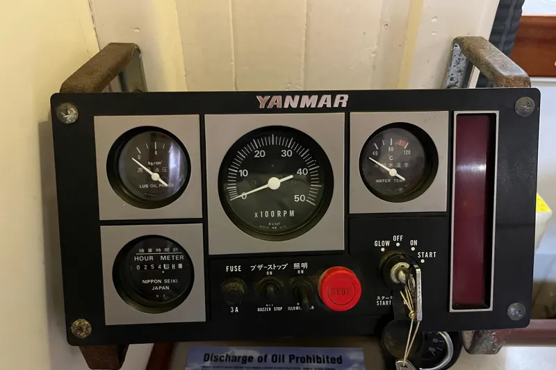 Slide: The Image of Yanmar engine control panel on 1947 Murray Peterson Schooner, displaying gauges and switches. - 73