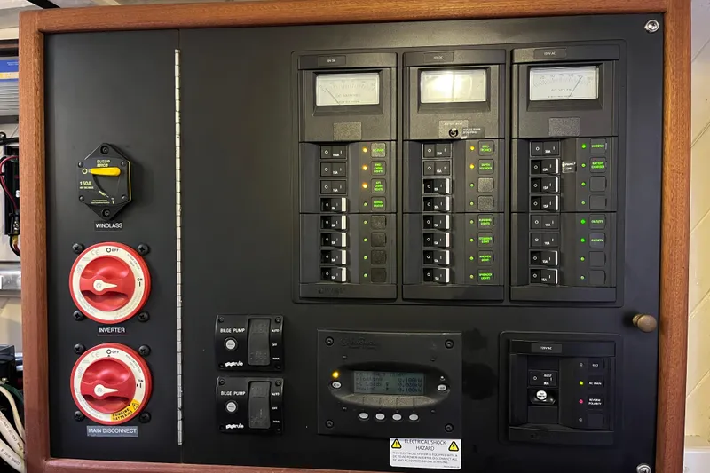 Slide: The Image of Electrical control panel on a 1947 Murray Peterson Schooner, featuring switches and gauges. - 74
