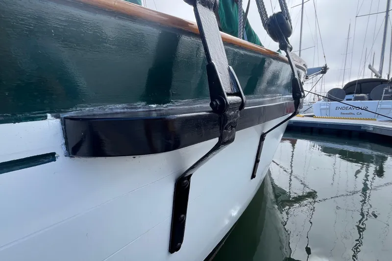 Slide: The Image of Close-up of 1947 Murray Peterson Schooner's side, docked in a marina. - 8