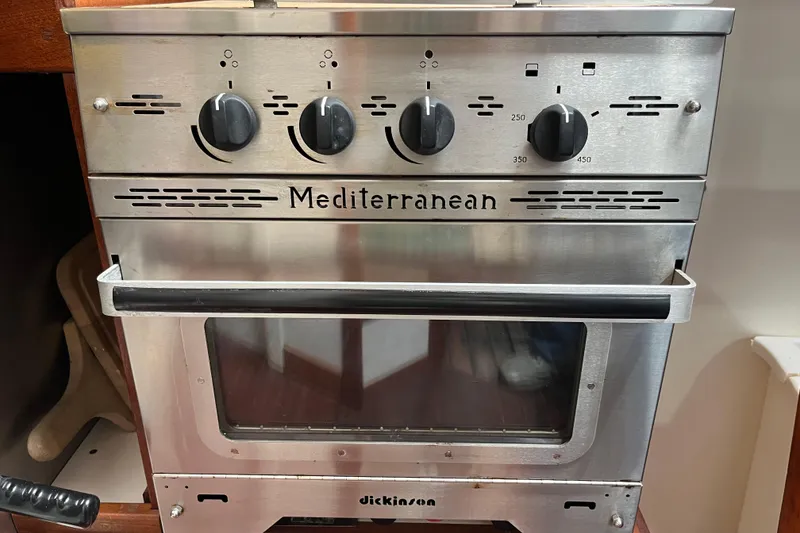 Slide: The Image of Stainless steel Mediterranean oven with control knobs, featuring a glass door and temperature settings. - 86