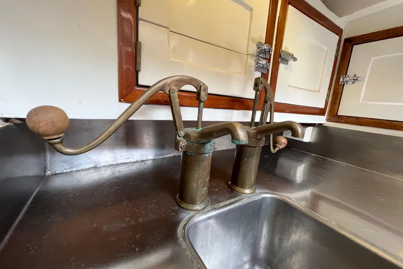 Slide: The Image of Vintage brass pump faucets in a 1947 Murray Peterson Schooner kitchen. - 87