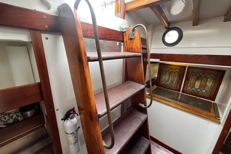 Slide: The Image of Interior of 1947 Murray Peterson Schooner with wooden ladder and stained glass windows. - 89