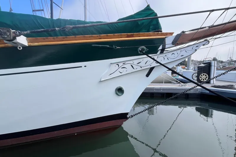 Slide: The Image of 1947 Murray Peterson Schooner with decorative bow detail docked at marina. - 9