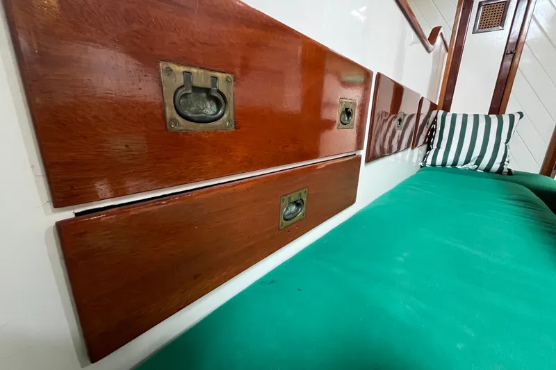 Slide: The Image of Vintage 1947 Murray Peterson Schooner interior with polished wood and green seating. - 90