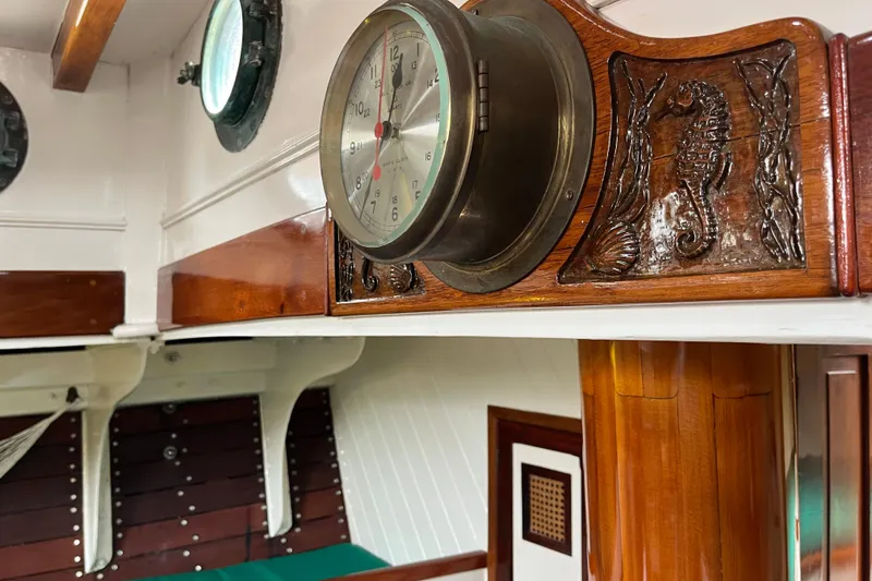 Slide: The Image of Interior of 1947 Murray Peterson Schooner with nautical clock and carved wood details. - 94