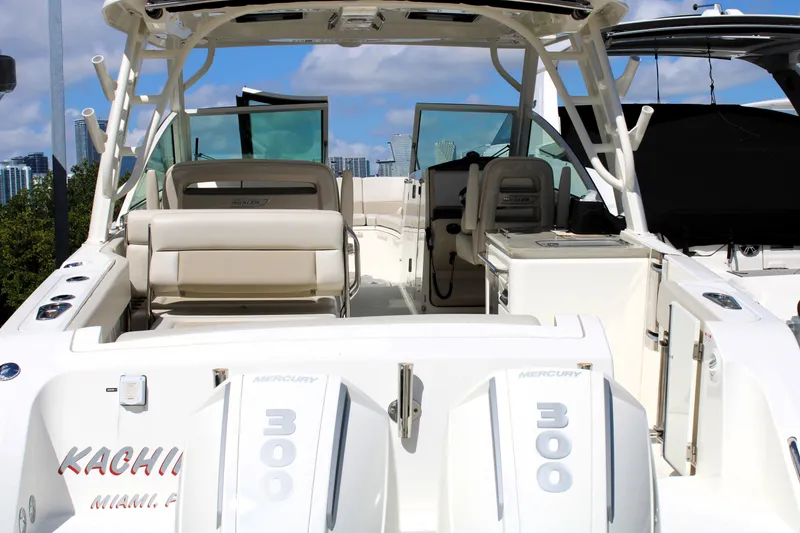 Slide: The Image of 2021 Boston Whaler 320 Vantage boat with dual Mercury 300 engines, docked in Miami. - 10
