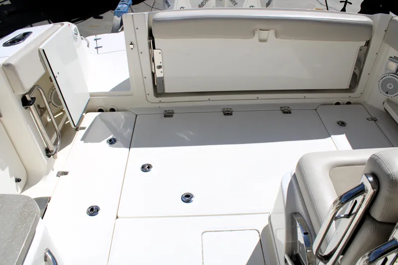 Slide: The Image of 2021 Boston Whaler 320 Vantage boat interior, featuring spacious seating and storage areas. - 16