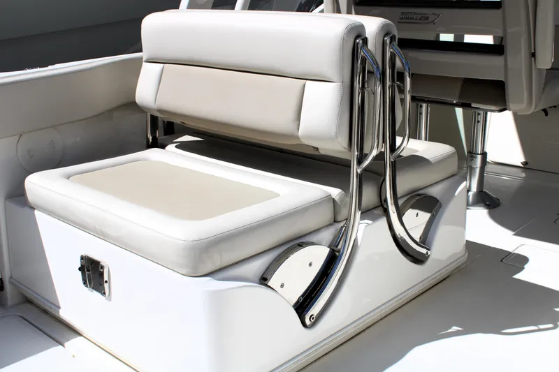 Slide: The Image of 2021 Boston Whaler 320 Vantage boat seating with chrome accents and cushioned upholstery. - 18