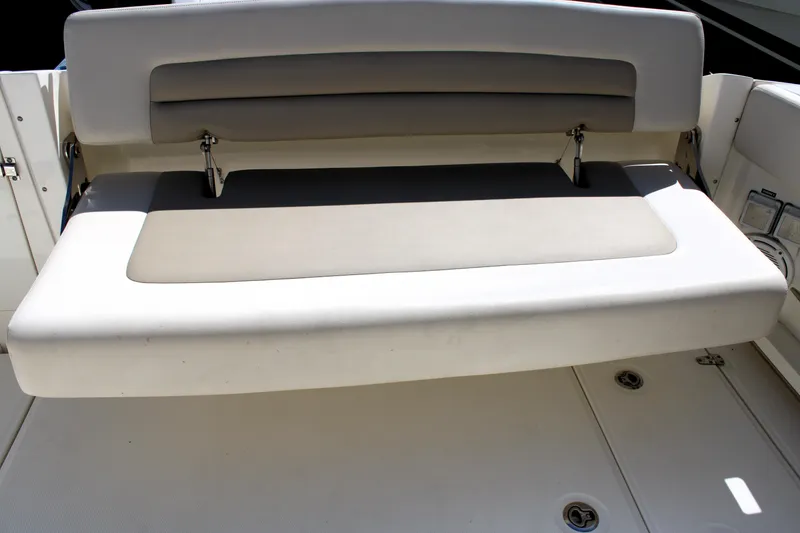 Slide: The Image of 2021 Boston Whaler 320 Vantage boat seat, featuring cushioned backrest and foldable design. - 20