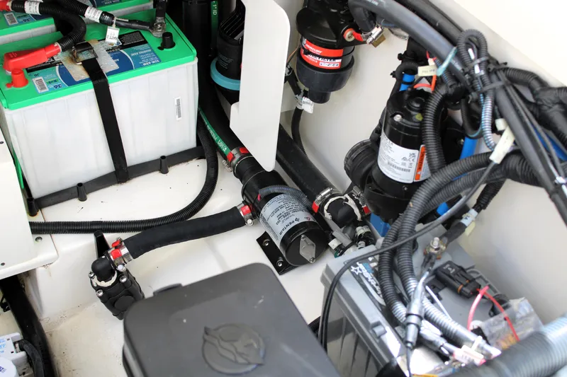 Slide: The Image of 2021 Boston Whaler 320 Vantage engine compartment with batteries and wiring. - 23