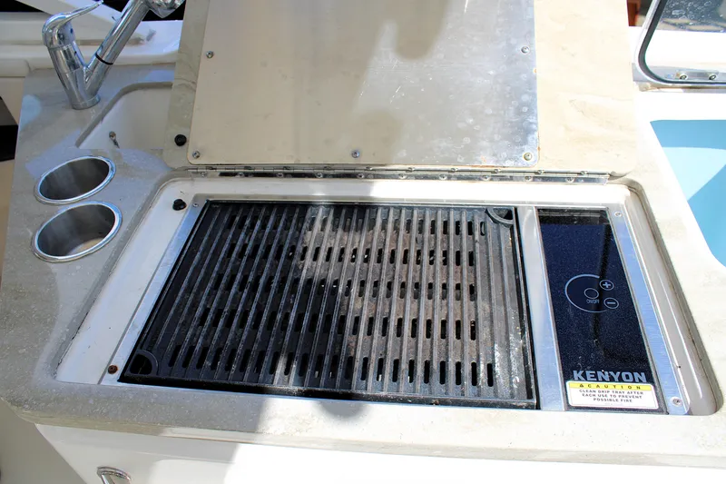 Slide: The Image of Outdoor grill on 2021 Boston Whaler 320 Vantage boat with dual cup holders. - 27
