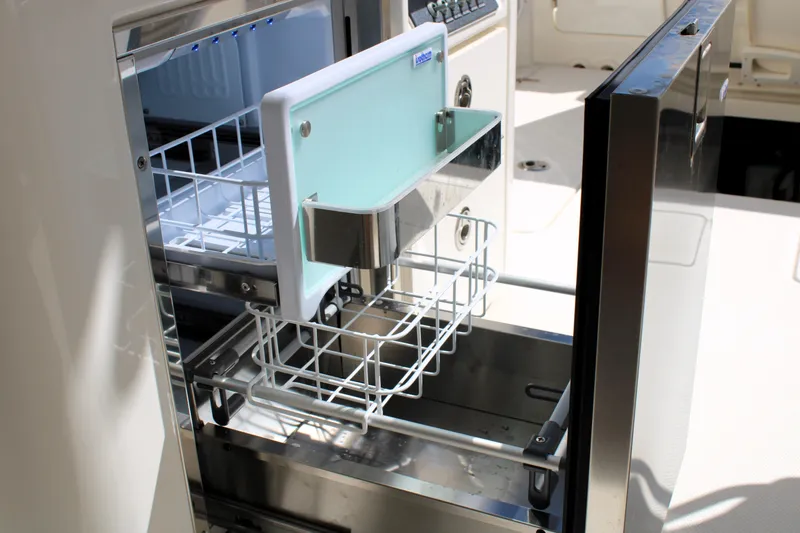 Slide: The Image of Open refrigerator drawer on 2021 Boston Whaler 320 Vantage boat, showcasing storage space. - 30