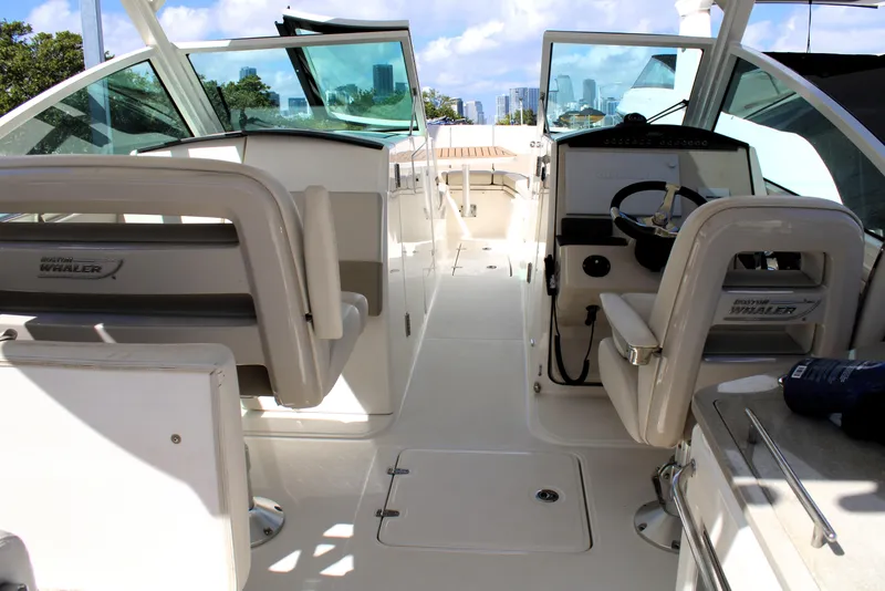 Slide: The Image of 2021 Boston Whaler 320 Vantage boat interior with helm and seating area. - 43