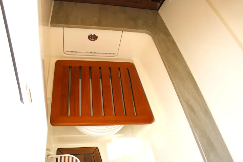 Slide: The Image of 2021 Boston Whaler 320 Vantage interior with wooden seat and countertop. - 54