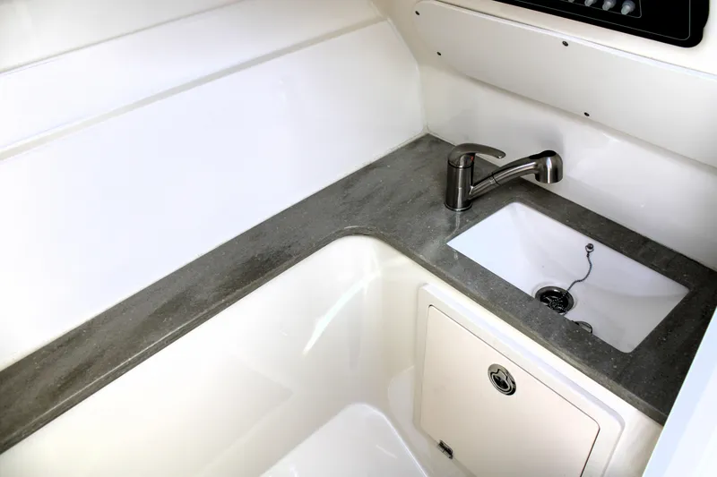 Slide: The Image of 2021 Boston Whaler 320 Vantage boat interior with sink and faucet. - 56