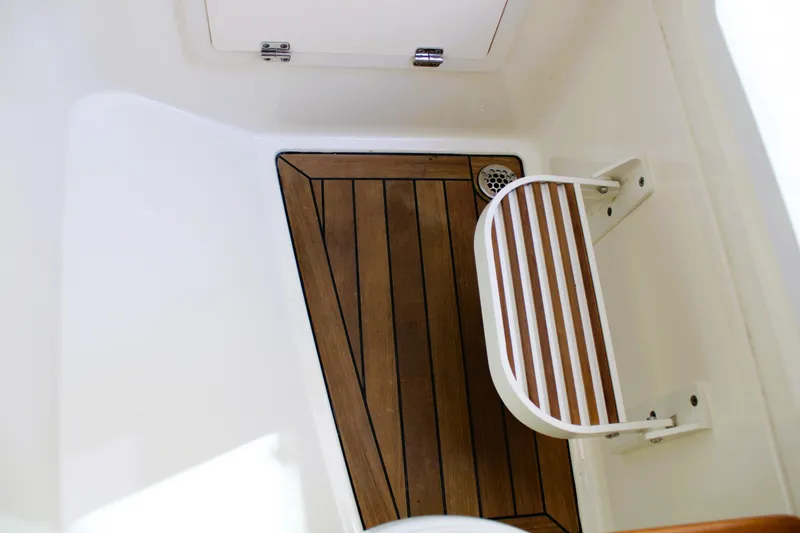 Slide: The Image of 2021 Boston Whaler 320 Vantage interior with wooden flooring and foldable seat. - 57