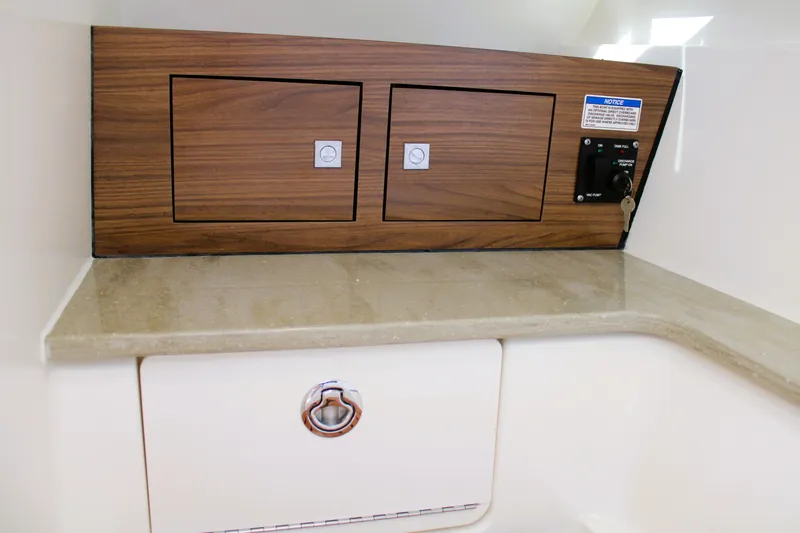Slide: The Image of 2021 Boston Whaler 320 Vantage interior with wood paneling and control panel. - 58