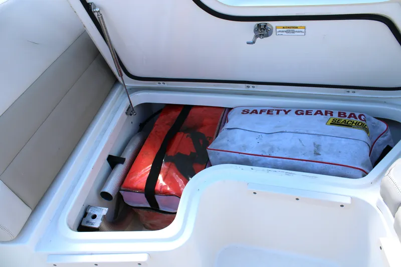 Slide: The Image of Storage compartment on 2021 Boston Whaler 320 Vantage with safety gear bag. - 59