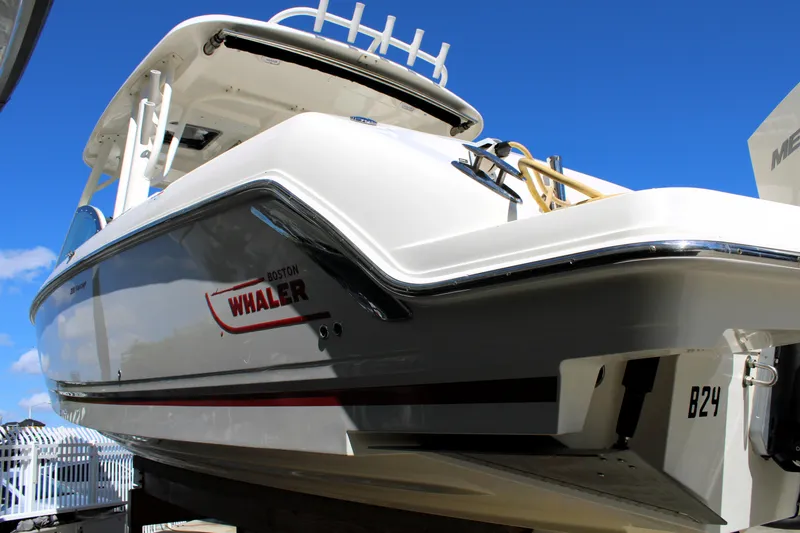 Slide: The Image of 2021 Boston Whaler 320 Vantage boat, docked under clear blue sky. - 6