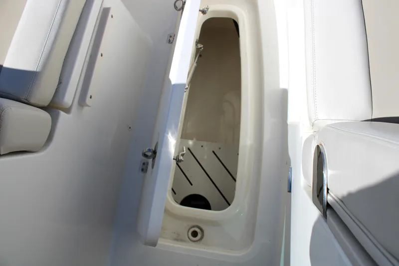 Slide: The Image of 2021 Boston Whaler 320 Vantage storage compartment with open hatch and seating. - 63