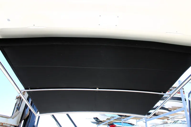 Slide: The Image of 2021 Boston Whaler 320 Vantage boat canopy with sleek black cover and metal frame. - 73