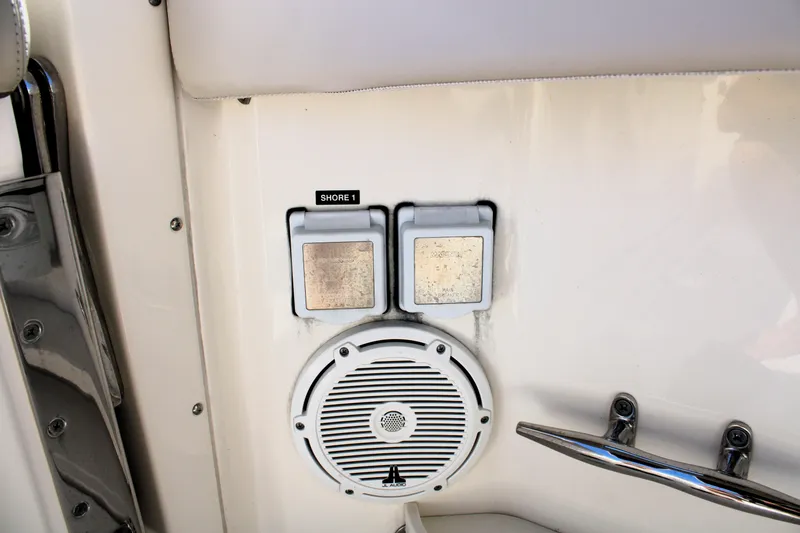 Slide: The Image of 2021 Boston Whaler 320 Vantage boat speaker and shore power outlet. - 77