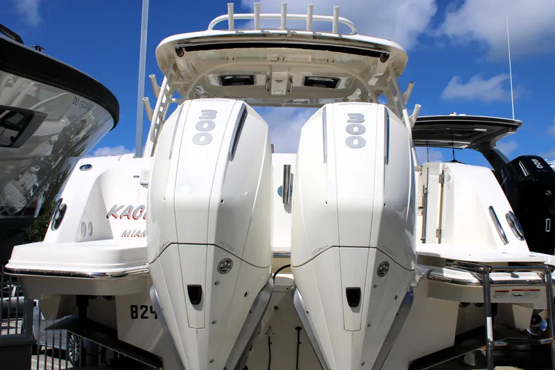 Slide: The Image of 2021 Boston Whaler 320 Vantage with dual 300 horsepower engines, docked under a clear blue sky. - 8