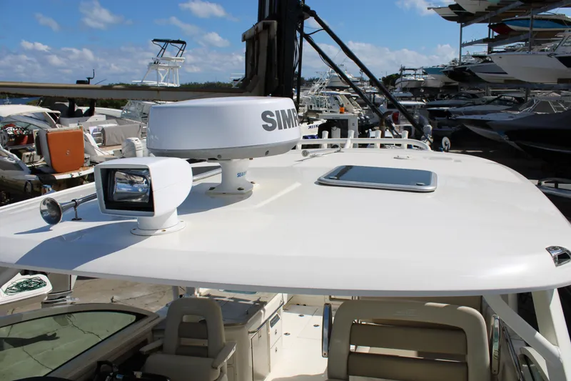 Slide: The Image of 2021 Boston Whaler 320 Vantage boat with radar and spotlight on deck. - 85