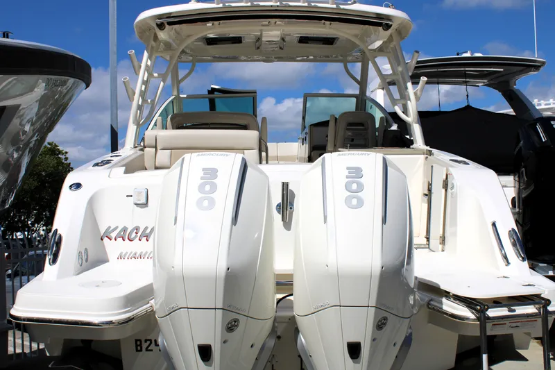Slide: The Image of 2021 Boston Whaler 320 Vantage with twin 300 horsepower engines, docked under a clear sky. - 9