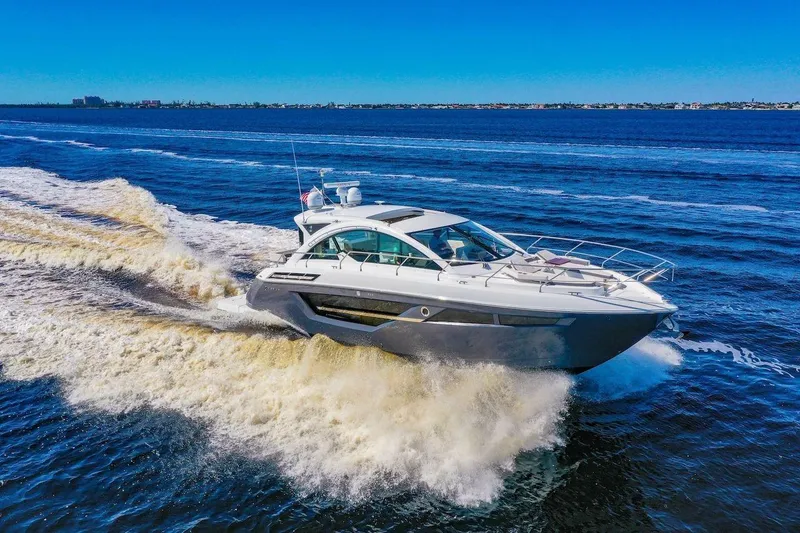 The Image of 2020 Cruisers Yachts 50 Cantius cruising on open water, creating a dynamic wake. - 0