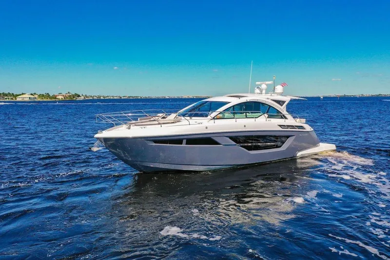 Slide: The Image of 2020 Cruisers Yachts 50 Cantius on open water under clear blue sky. - 1
