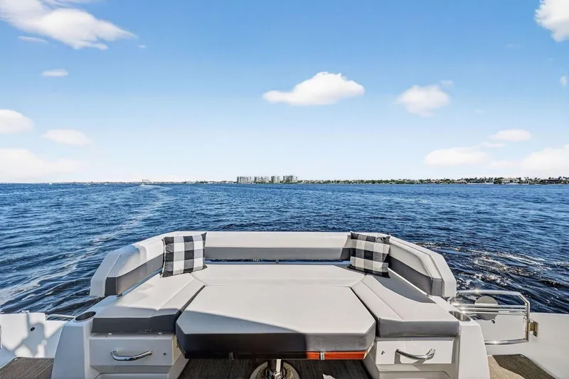 Slide: The Image of 2020 Cruisers Yachts 50 Cantius, rear seating view, open water, clear sky. - 15