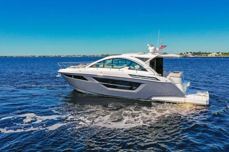 Slide: The Image of 2020 Cruisers Yachts 50 Cantius on open water, sleek design, sunny day. - 2
