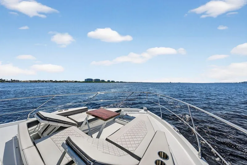 Slide: The Image of 2020 Cruisers Yachts 50 Cantius on open water under blue sky. - 20