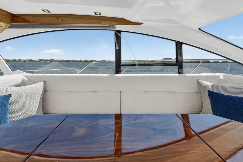 Slide: The Image of Luxurious interior of 2020 Cruisers Yachts 50 Cantius with elegant seating and wooden table. - 29