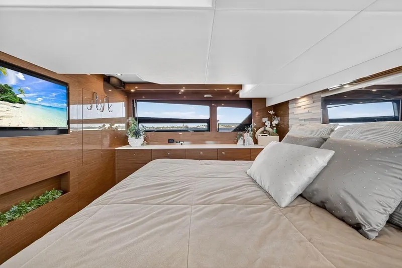 Slide: The Image of Luxurious 2020 Cruisers Yachts 50 Cantius bedroom with elegant decor and scenic window views. - 53