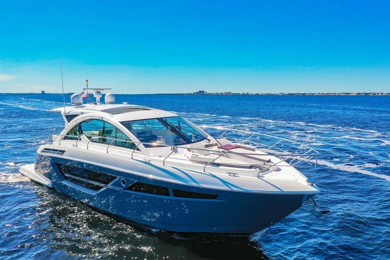 Slide: The Image of 2020 Cruisers Yachts 50 Cantius sailing on a clear blue ocean under a sunny sky. - 6
