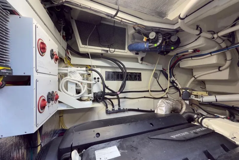 Slide: The Image of Engine room of 2020 Cruisers Yachts 50 Cantius, featuring complex wiring and mechanical components. - 60