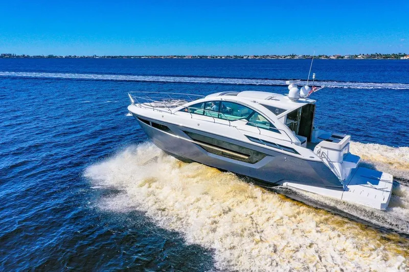 Slide: The Image of 2020 Cruisers Yachts 50 Cantius cruising on open water under clear blue skies. - 7