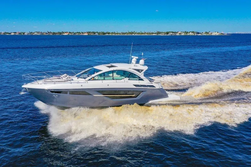 Slide: The Image of 2020 Cruisers Yachts 50 Cantius cruising on open water under clear blue skies. - 8