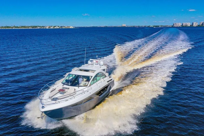 Slide: The Image of 2020 Cruisers Yachts 50 Cantius cruising on open blue water, leaving a wake. - 9
