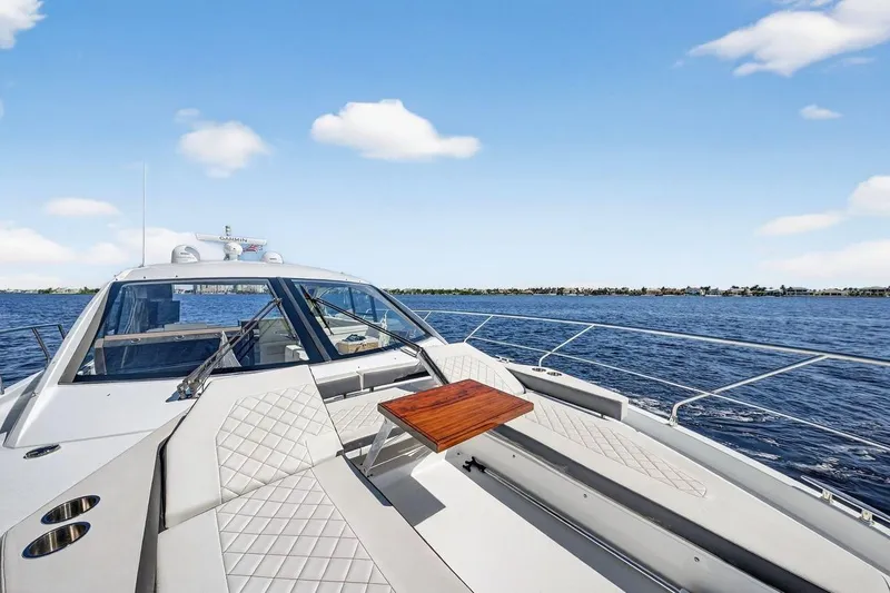 Slide: The Image of 2020 Cruisers Yachts 50 Cantius on open water, featuring sleek deck and seating area. - 19