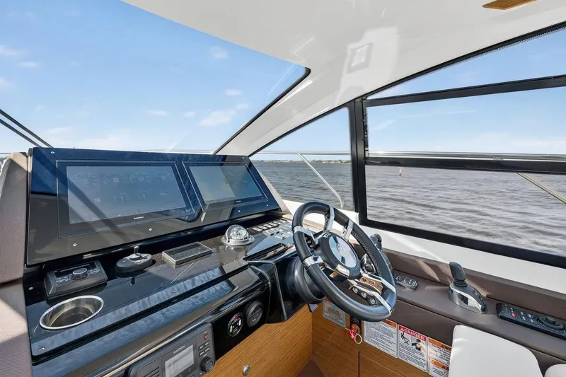 Slide: The Image of Helm of 2020 Cruisers Yachts 50 Cantius with modern navigation equipment and scenic water view. - 28