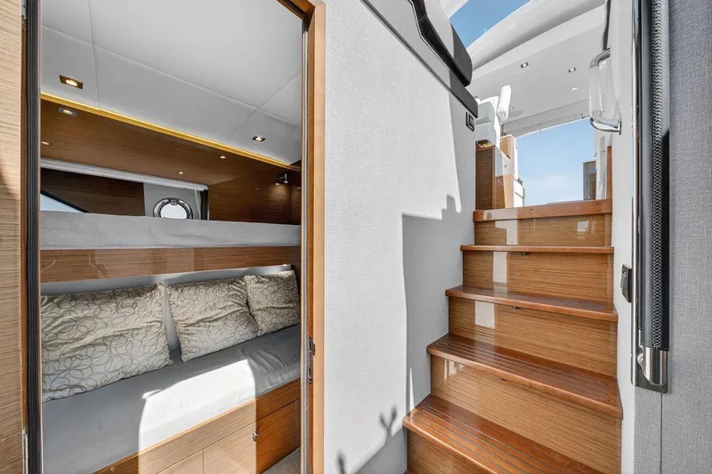 Slide: The Image of 2020 Cruisers Yachts 50 Cantius interior with wooden stairs and cozy cabin. - 45