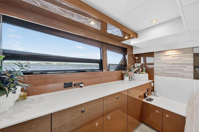 Slide: The Image of Luxurious interior of 2020 Cruisers Yachts 50 Cantius with elegant wood cabinetry and scenic window view. - 57